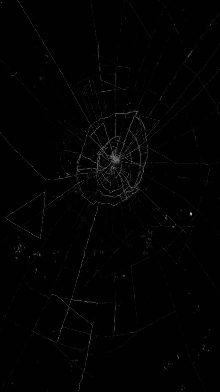 Animation of broken glass screen with central impact point, seamless loop overlay for social media on black background