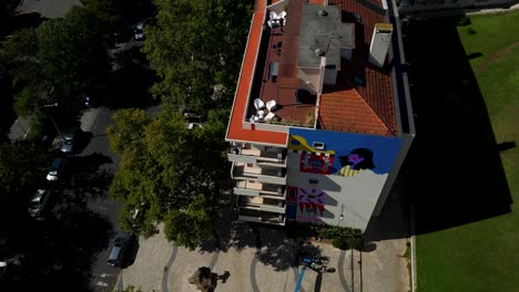 Urban-art-in-Lisbon,-showcasing-the-reconstruction-and-restoration-of-cultural-heritage-with-a-view-of-the-Tagus-River-on-a-sunny-day