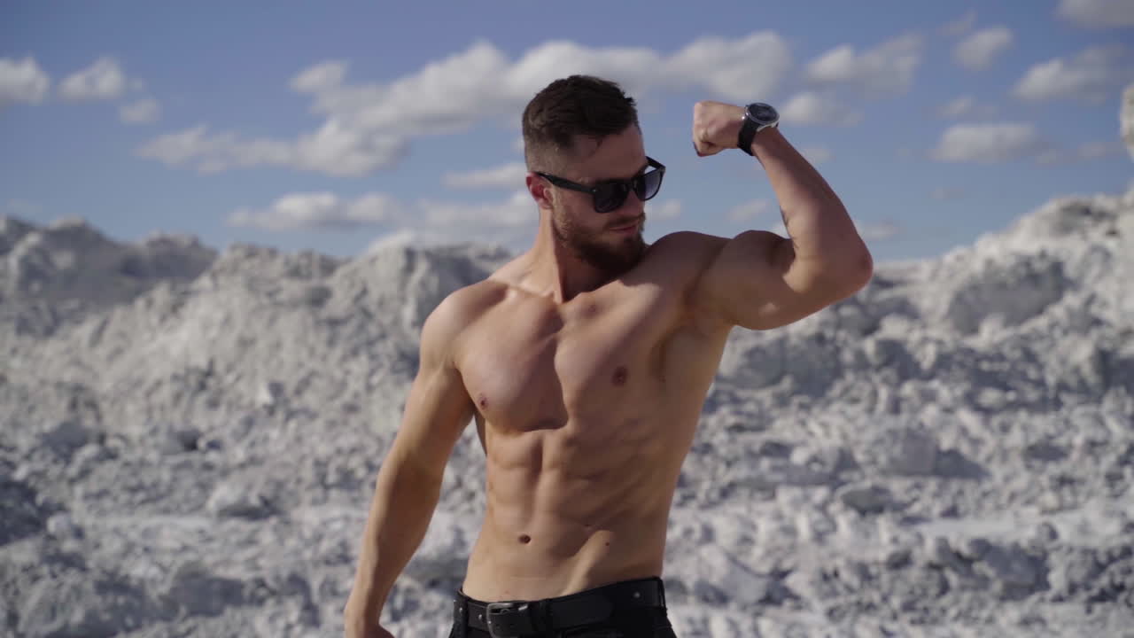 Muscular man posing outdoors. Handsome muscular shirtless hunk man outdoor