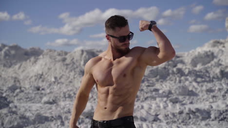 muscular man posing outdoors. handsome muscular shirtless hunk man outdoor