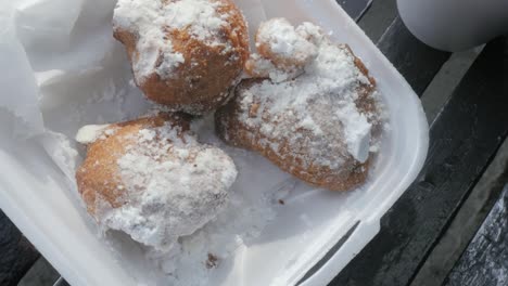 beignet pastries in a foam takeaway box in the french quarter, new orleans