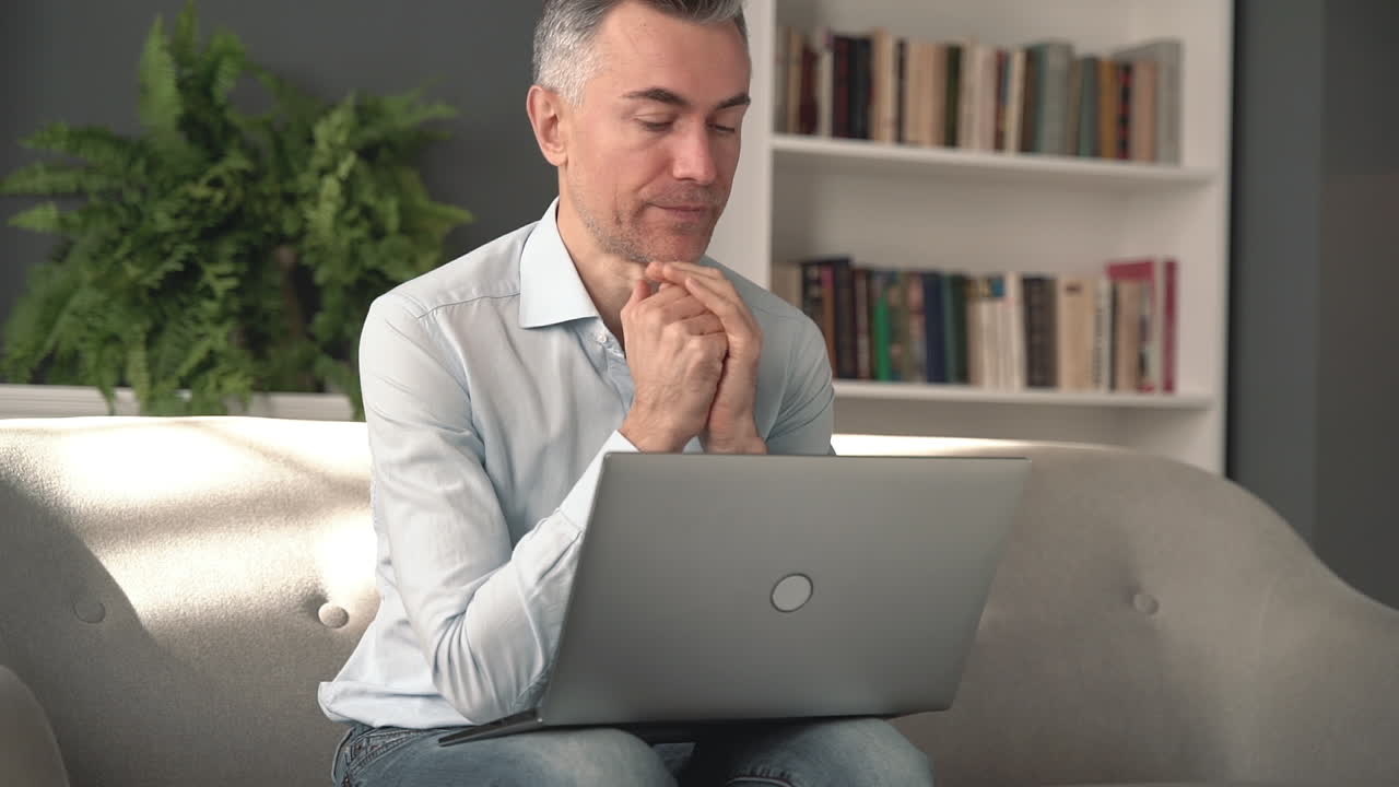 Tired and stressed man working with a computer. Mature male worried and thinking.