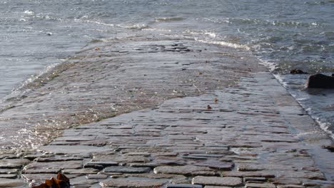 wide shot of the tide revealing the causeway at st michaels mount