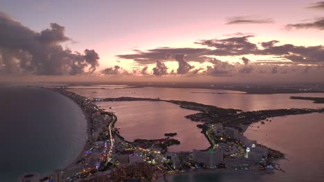 aerial view over oceanside resorts and beaches, in hotel zone of cancun, mexico - reverse, drone shot