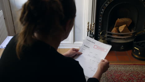 an unrecognizable female opening a debt letter