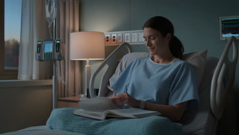 woman reading a book in a hospital bed