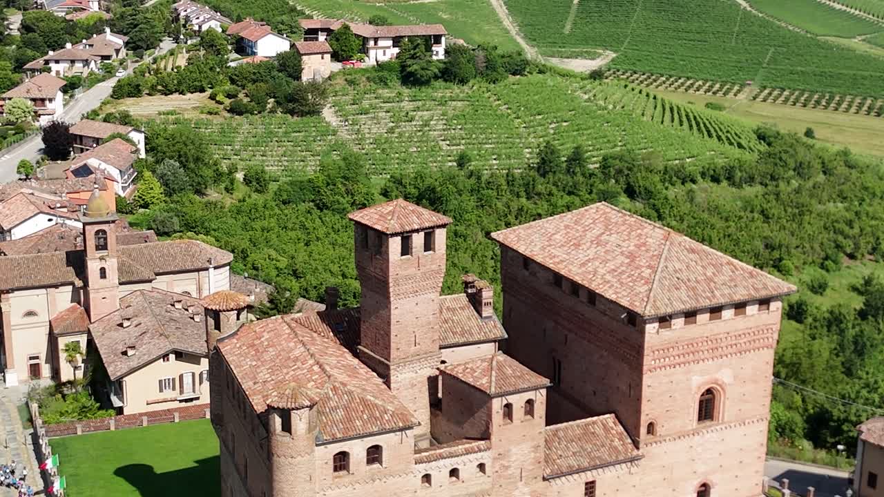 Grinzane Cavour castle, UNESCO site, Cuneo, Piedmont, Italy. 4k aerial view of the castle together with the Vineyard. Langhe-Roero and Monferrato. Circling to the right.