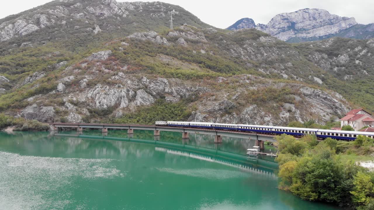 Aerial: Golden Eagle Danube Express train by the Neretva River in Bosnia and Hercegovina