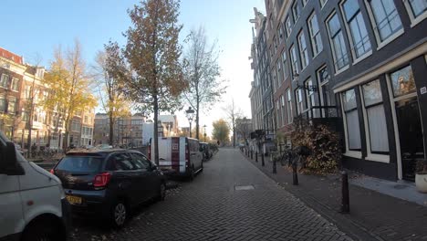 time warp biking through the city centre of amsterdam passing the major attractions such as the typical canal neighbourhood and ending up looking up at the national museum