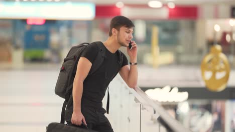Young-man-speaking-on-the-the-phone-in-the-mall