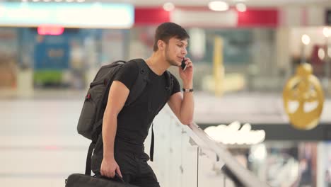 young man speaking on the the phone in the mall