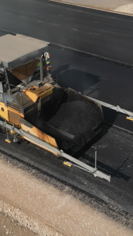 road construction: asphalt paving with heavy machinery
