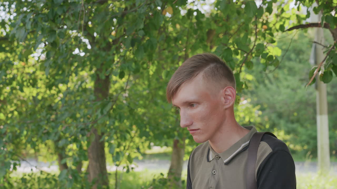 Serene Person Standing Quietly Near Foliage, Meditative Individual Pausing Peacefully Under Shade Of Leaves, Reflective Person Taking Tranquil Break Surrounded By Lush Leafy Shelter
