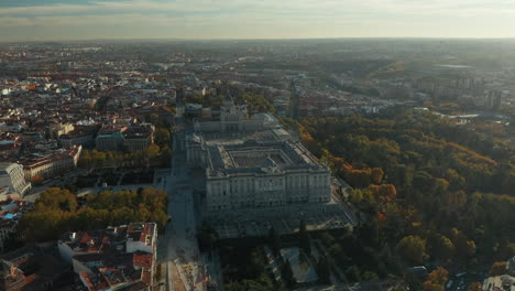 Aerial-panoramic-footage-of-city-in-sunset-time.-Majestic-building-on-Royal-Palace-complex-and-surrounding-parks-and-gardens.