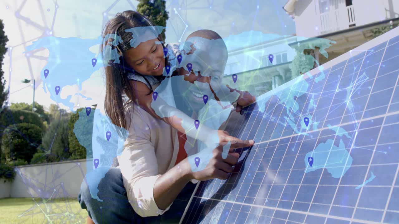 Adult pointing solar cell while child on back, map overlay initiating pins linking energy grid