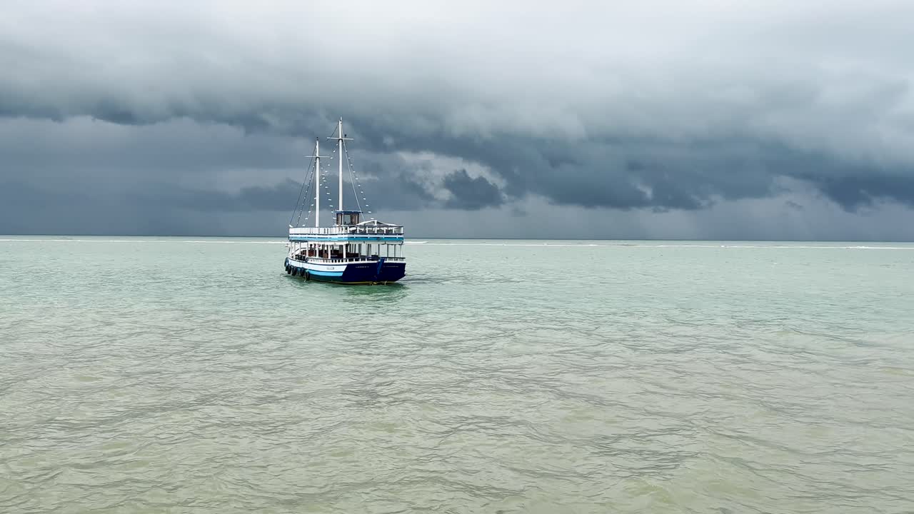 Boat sailing in calm sea under cloudy sky in Brasil