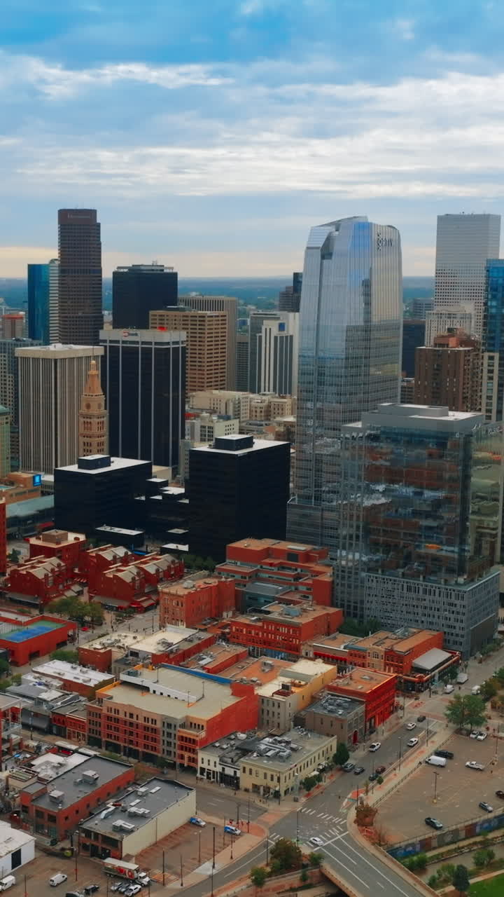 Beautiful sight of Denver downtown with varied skyscrapers. Vast scenery of the metropolis on cloudy day. Top view. Vertical video
