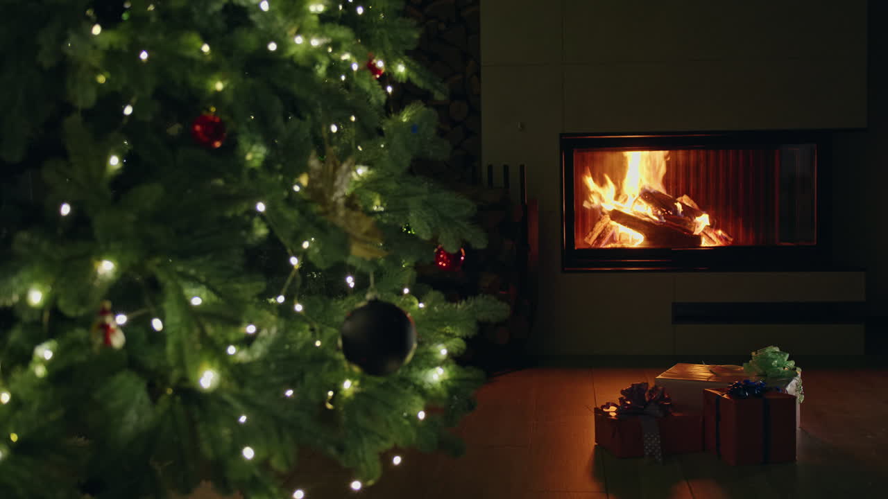 Christmas tree with gifts in front of a fireplace