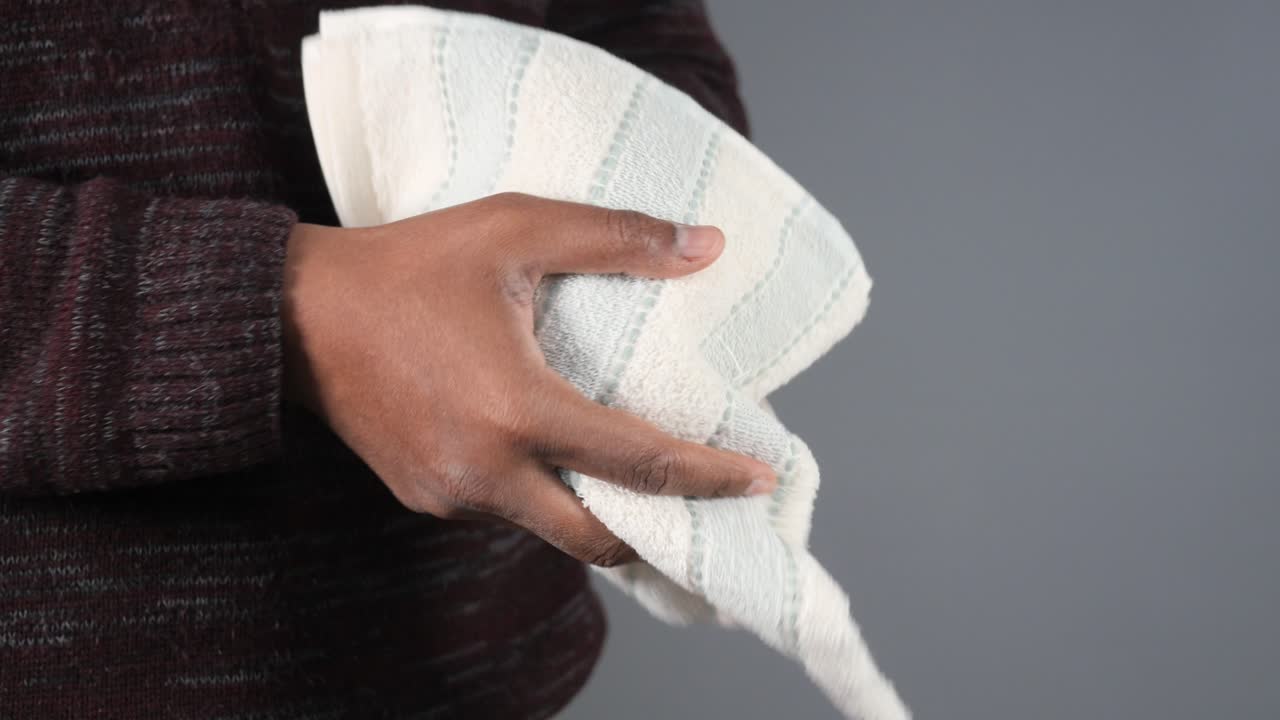 Person Wiping Hands with a Towel