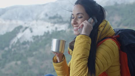 Happy-female-hiker-on-phone