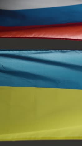 vertical shot of ukrainian and russian flags 01