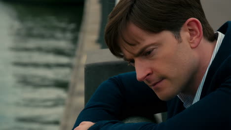 contemplative man on a bridge