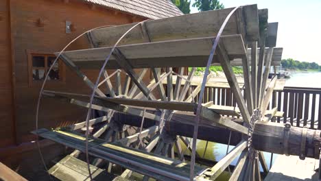 close up of large waterwheel powering ship mill on danube river, baja, hungary.