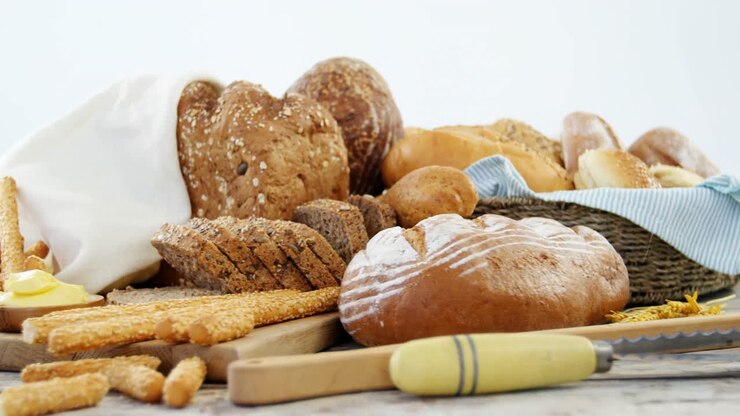 Various bread loaves on wooden table