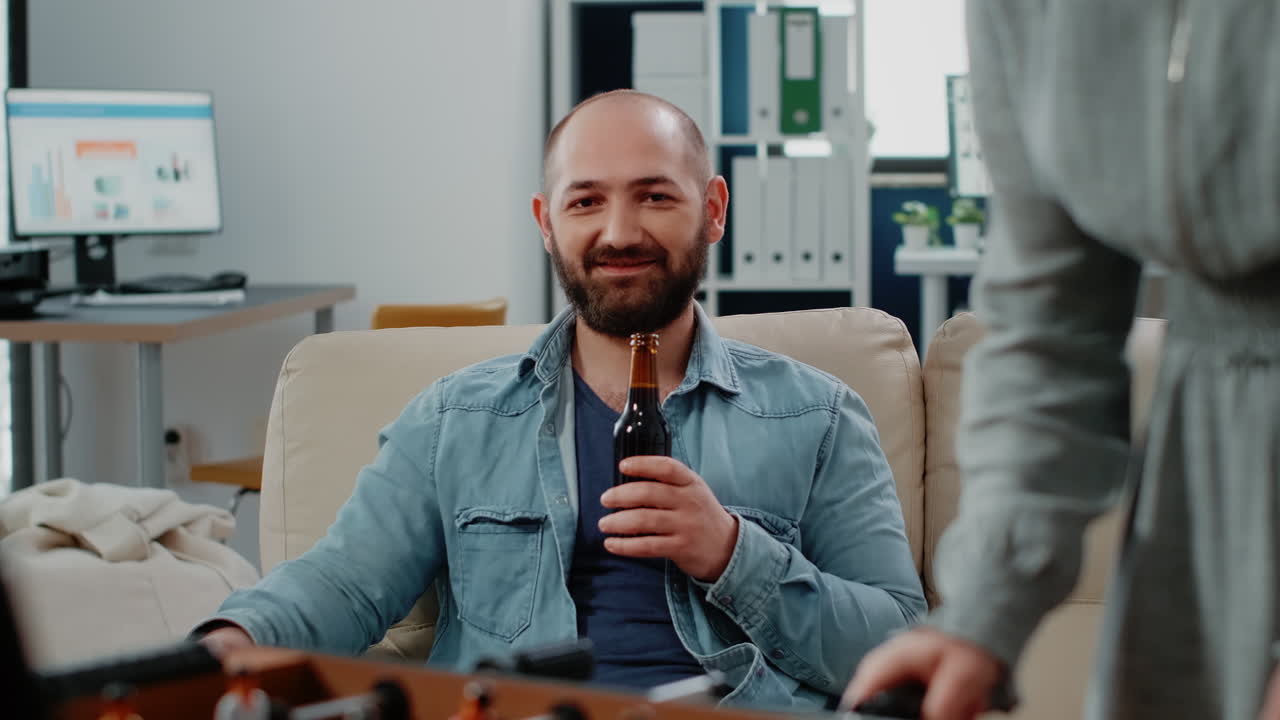 Portrait of businessman holding bottle of beer after work