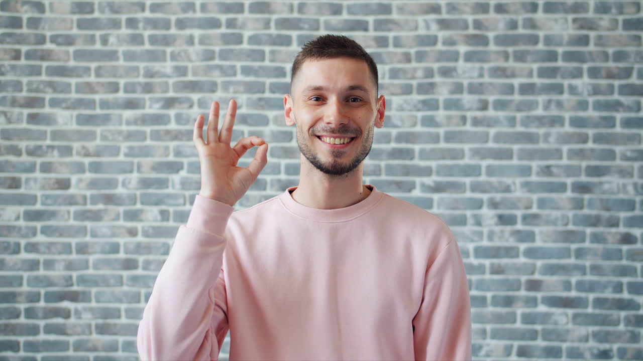 Man Smiling and Making an Ok Gesture