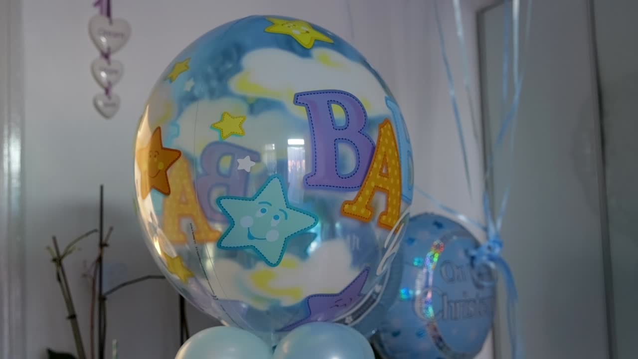 Colorful 'BABY' balloons with stars for a joyful baby shower event