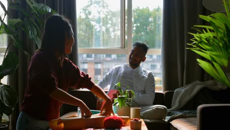 side view of young asian woman packing a gift in living room at home 4k