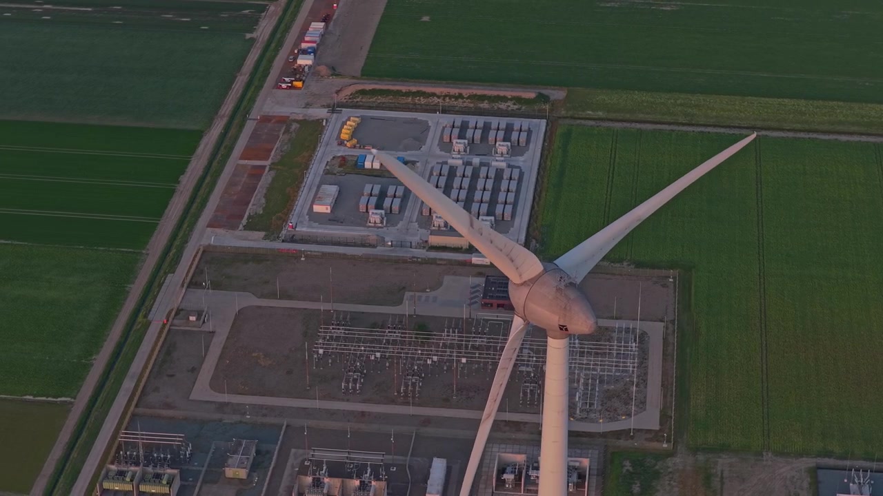 Aerial View of Wind Turbine and Electrical Substation at Sunset