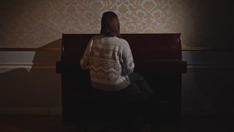 woman playing piano in a classic room