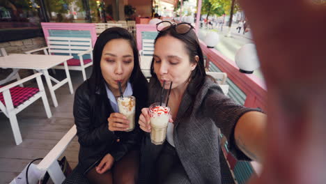 friends taking a selfie in a cafe