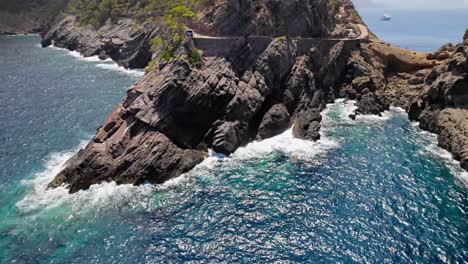 Rough-cliff-cove-with-waves-coming-in-circle-around-by-drone