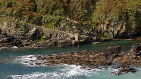 Looking-down-and-across-to-Bessy's-Cove,-The-Enys,-cornwall