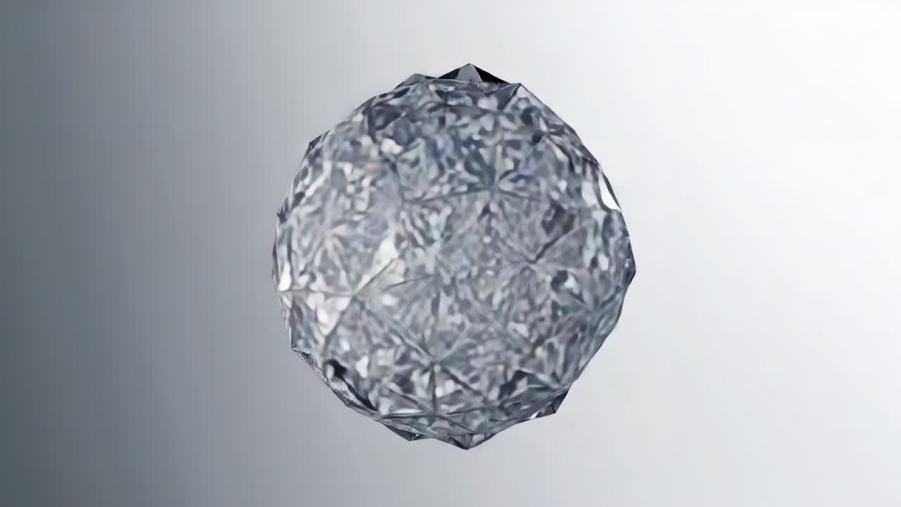 Playback starting faceted crystal sphere rotating slowly at gray backdrop, showing reflections