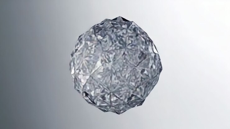 Playback starting faceted crystal sphere rotating slowly at gray backdrop, showing reflections