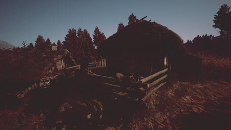 rustic cabins nestled among trees at dusk in a tranquil natural setting