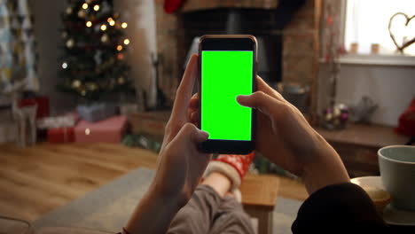 woman on line with mobile phone in room ready for christmas