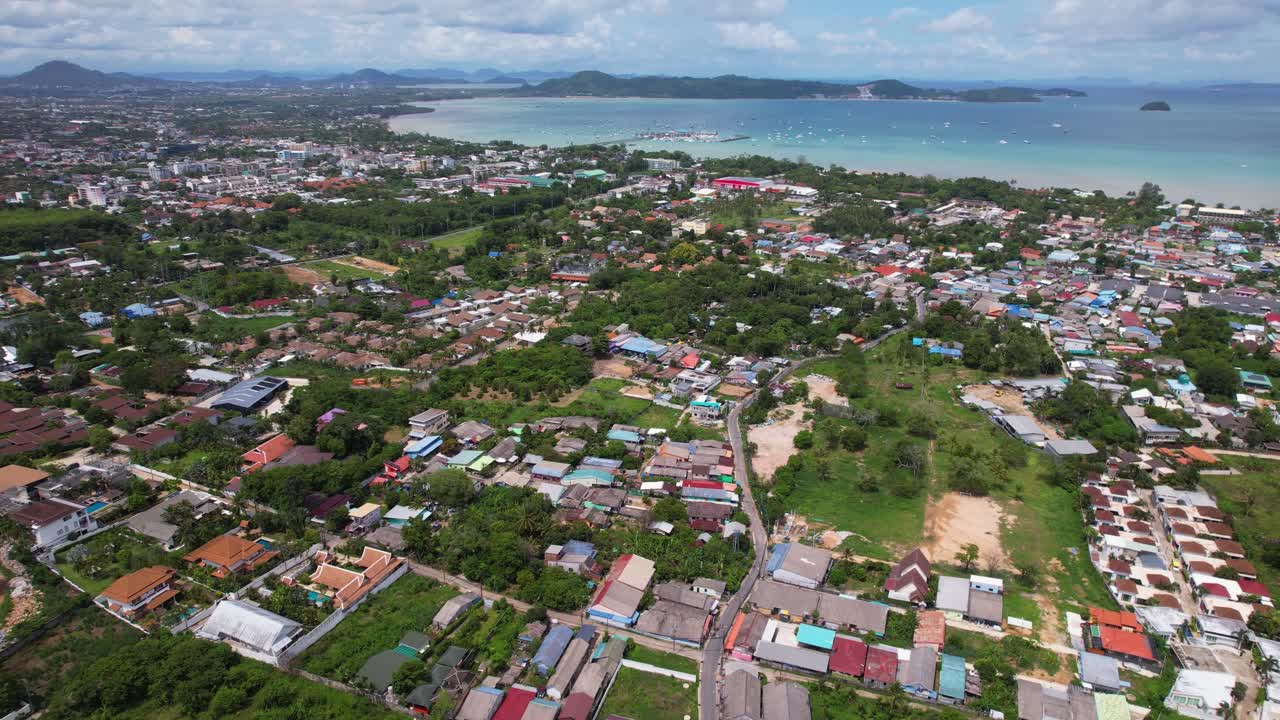 Thailand Phuket, aerial drone shot over a Rawai Mueang district on a beautiful sunny day, a turquoise lagoon facing Phi Phi island