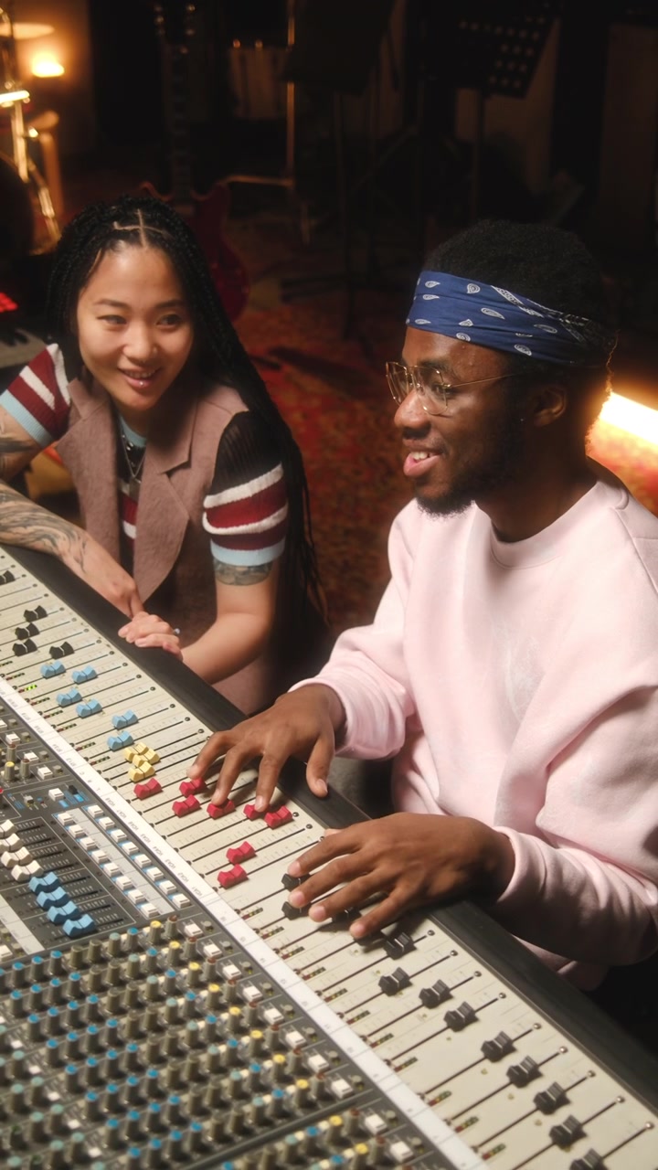 Diverse Musicians Discussing Audio Tracks while Cooperating in Recording Studio