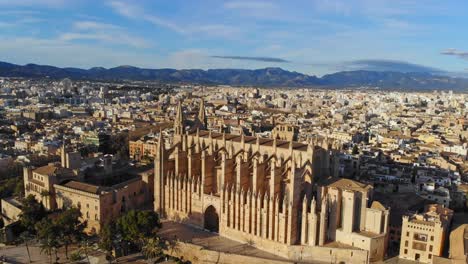 palma cathedral by drone with the city and mountains in background