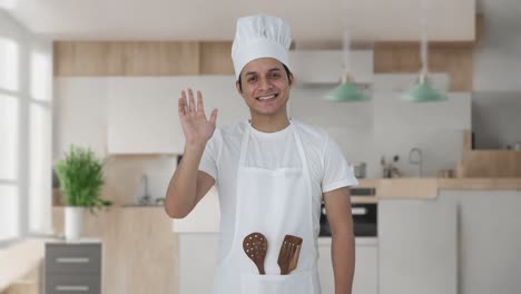 happy indian professional chef saying hello