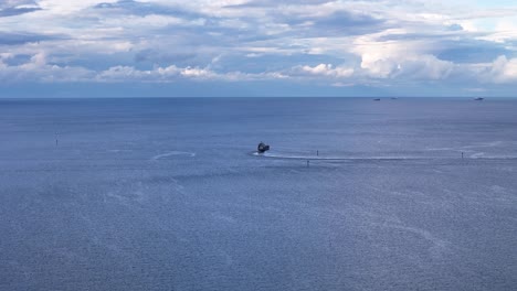cargo ships peacefully sail on the baltic sea near gdansk, poland, showcasing the beauty of the ocean and the importance of global trade slow motion aerial shot