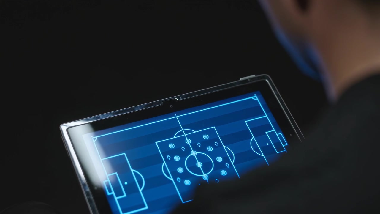 Tilting adult male recentering tablet in dark room after noticing glare to view blue pitch map