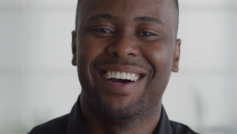 Portrait-happy-african-american-businessman-smiling-in-office-back-to-work