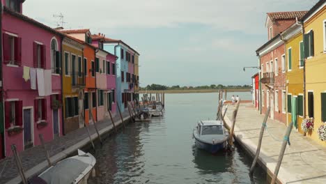 beautiful colorful buildings next to canal at burano