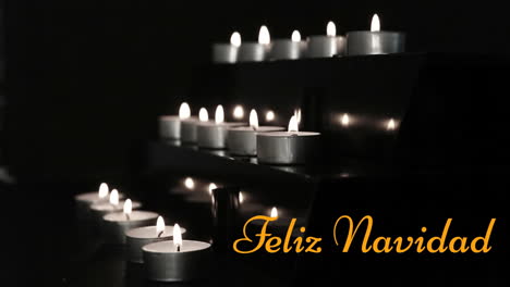 animation of feliz navidad text over burning set of candles against black background